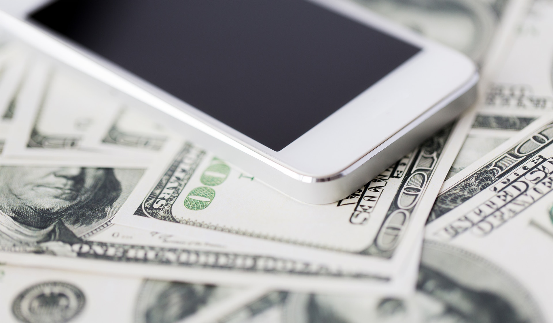 close up of smartphone and dollar money