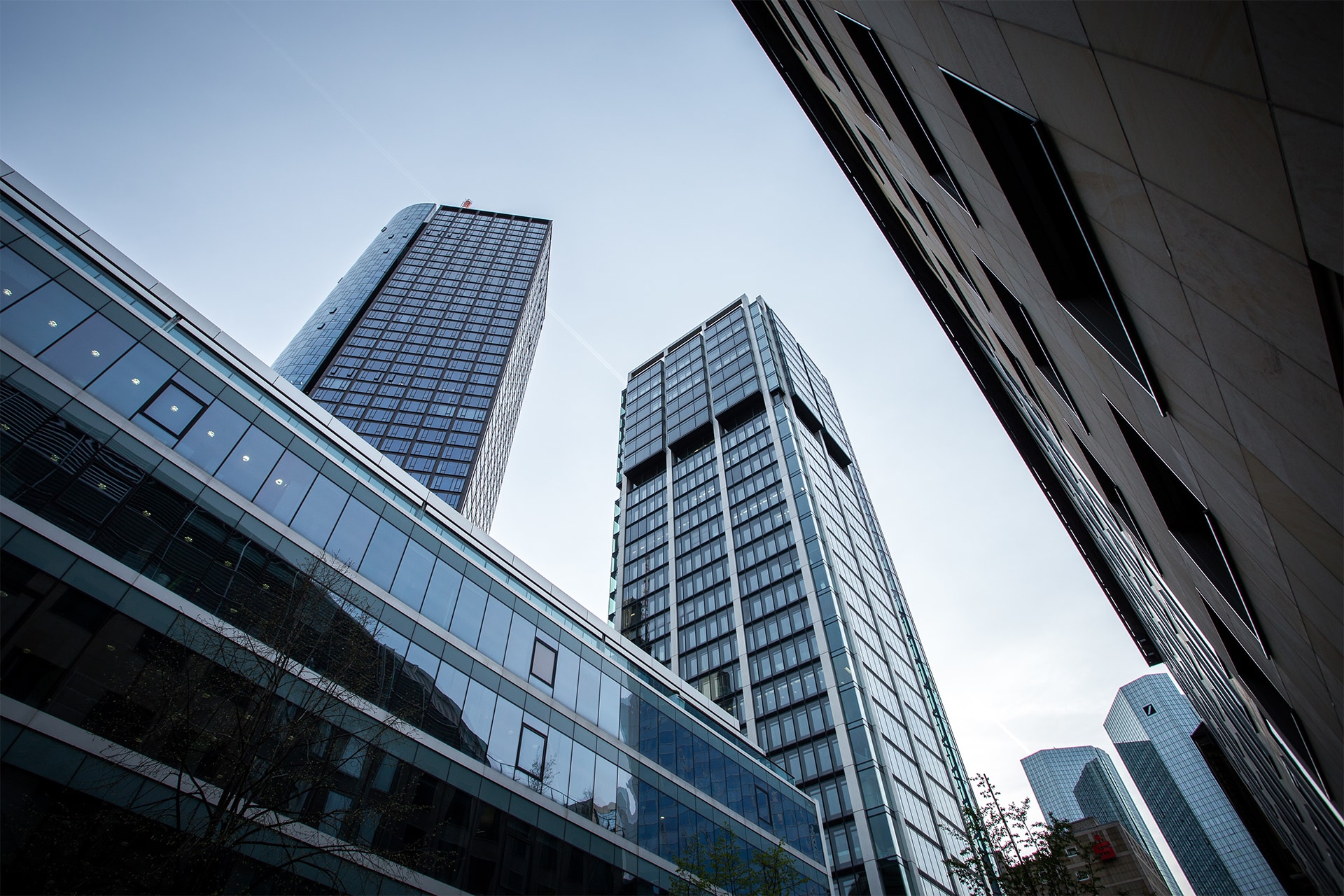 Low angle shot of high rise buildings under the clear sky low-angle-shot-high-rise-buildings-clear-sky-frankfurt-germany